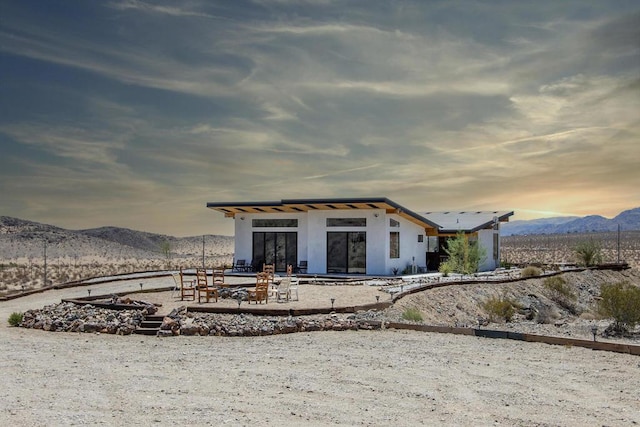 back house at dusk featuring a mountain view