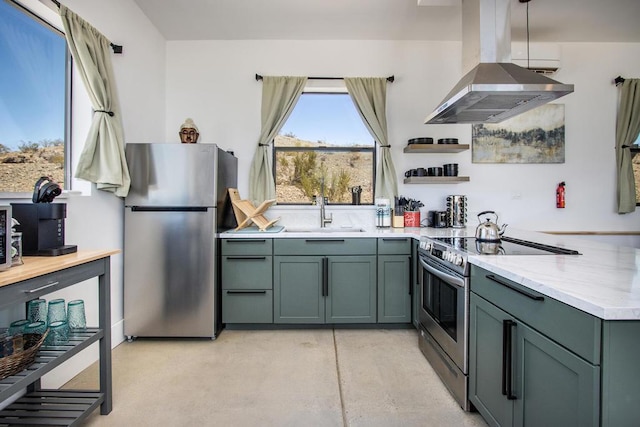 kitchen with light stone countertops, sink, appliances with stainless steel finishes, and island range hood