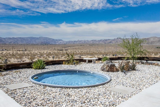 view of pool with a mountain view and a jacuzzi