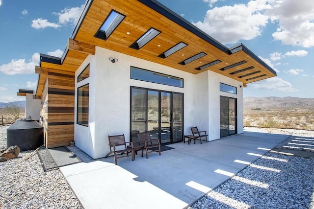 exterior space with a mountain view and a patio