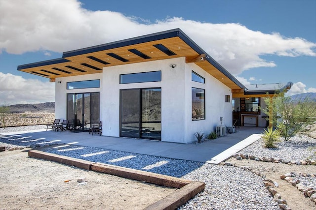 back of house with a patio area and a mountain view