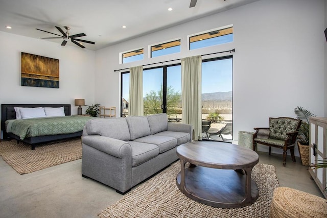 living room with ceiling fan, plenty of natural light, and a mountain view