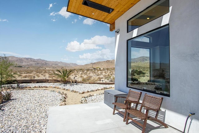 view of patio / terrace featuring a mountain view