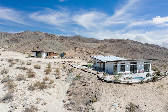 back of house featuring a mountain view