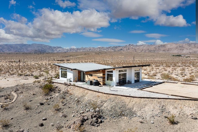 exterior space featuring a mountain view and a patio