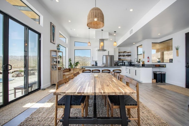 dining room with sink and light hardwood / wood-style flooring