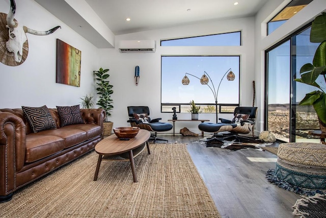 interior space featuring vaulted ceiling, a wall mounted AC, and wood-type flooring