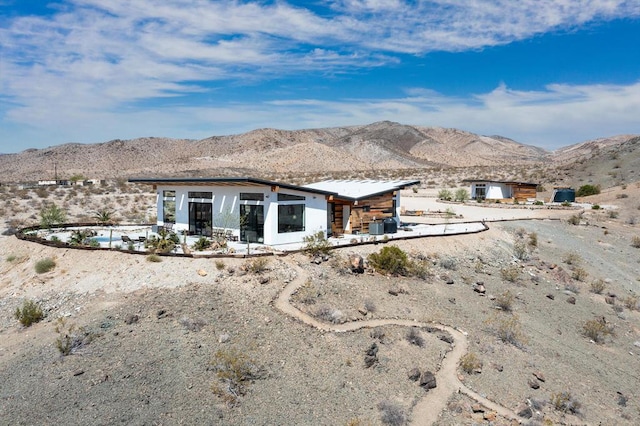 rear view of house featuring a mountain view