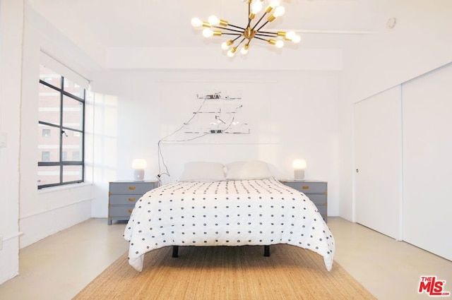 bedroom featuring a closet and a notable chandelier