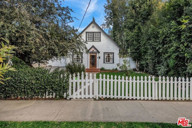 english style home with a front lawn