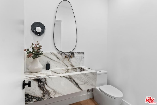 bathroom with backsplash and toilet