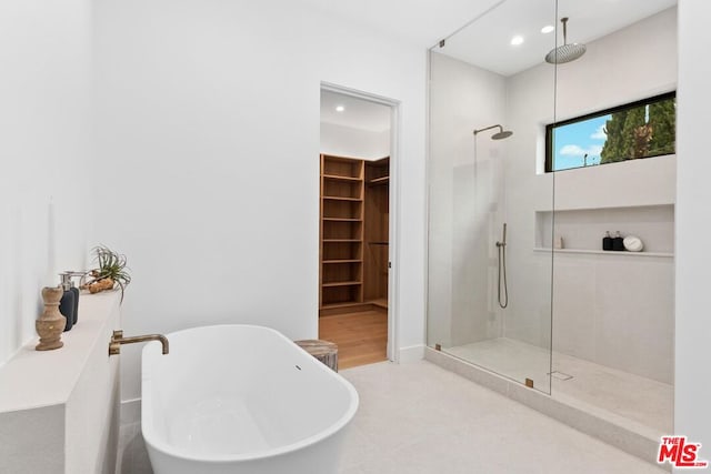 bathroom featuring independent shower and bath and tile patterned flooring