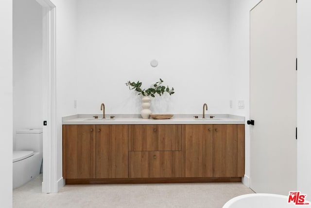 bathroom with vanity and toilet