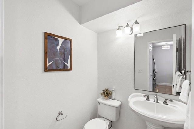 bathroom with toilet and sink