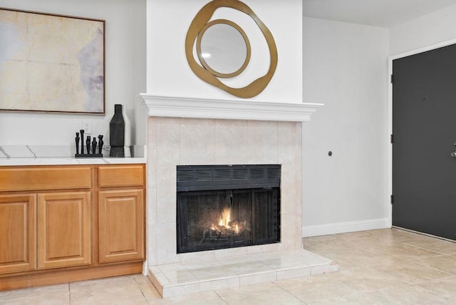 interior details featuring a tiled fireplace