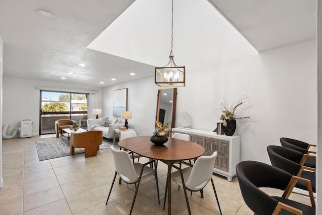 tiled dining space with a chandelier