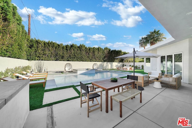 view of patio / terrace with a fenced in pool and an outdoor hangout area