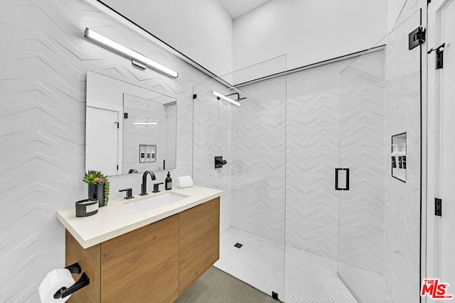 bathroom featuring an enclosed shower and vanity