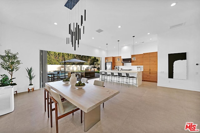 dining space featuring a high ceiling