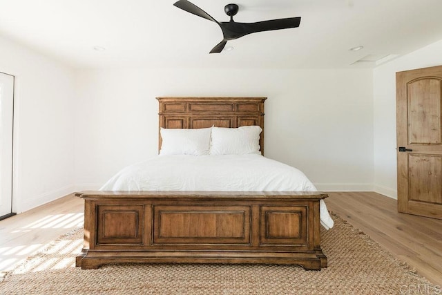 unfurnished bedroom with ceiling fan and light wood-type flooring