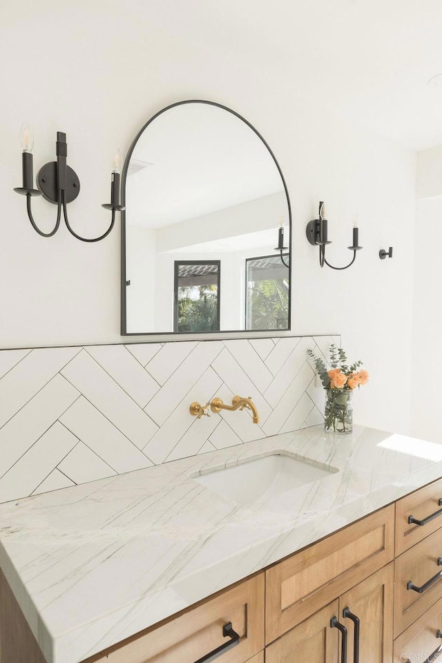 bathroom featuring decorative backsplash and vanity