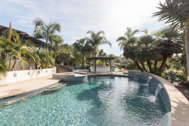 view of pool with a patio, a pool with connected hot tub, and a gazebo