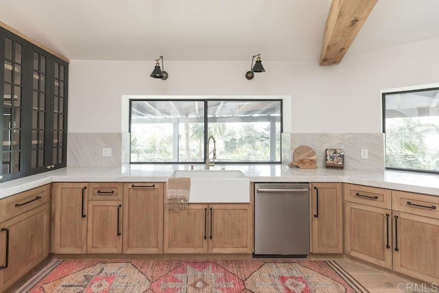 kitchen featuring a sink, light countertops, tasteful backsplash, stainless steel dishwasher, and beamed ceiling