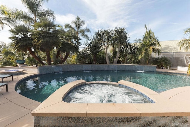 view of swimming pool featuring a pool with connected hot tub
