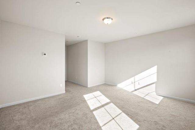 spare room featuring light colored carpet