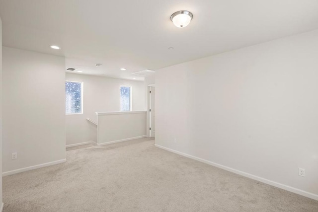 unfurnished room with light carpet