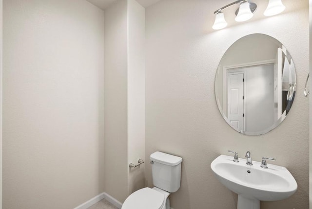 bathroom featuring sink and toilet