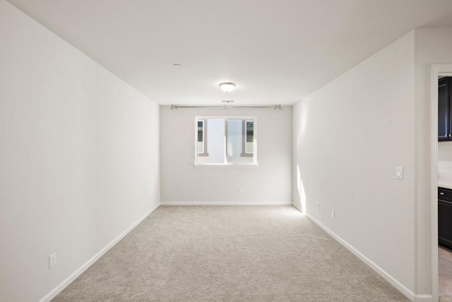 unfurnished room with light carpet