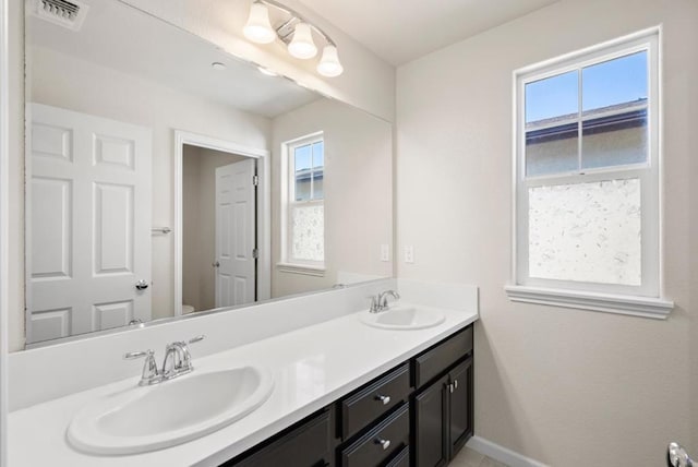 bathroom featuring toilet and vanity