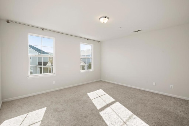 unfurnished room with light colored carpet