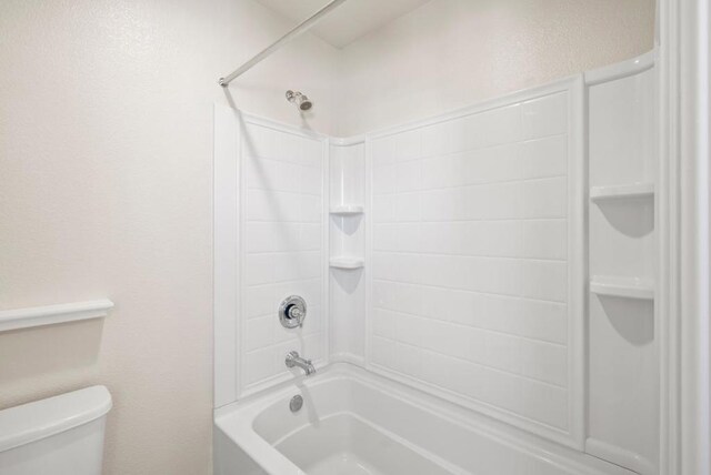 bathroom with toilet and bathtub / shower combination