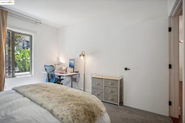 bedroom with dark colored carpet