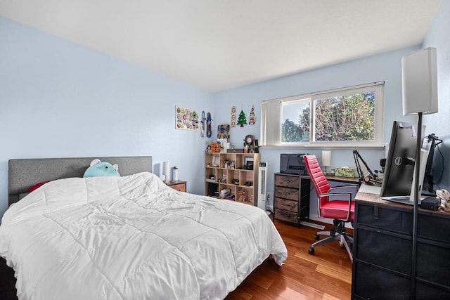 bedroom with hardwood / wood-style flooring