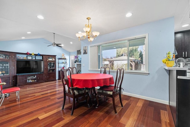 dining area with hardwood / wood-style flooring, lofted ceiling, and ceiling fan with notable chandelier