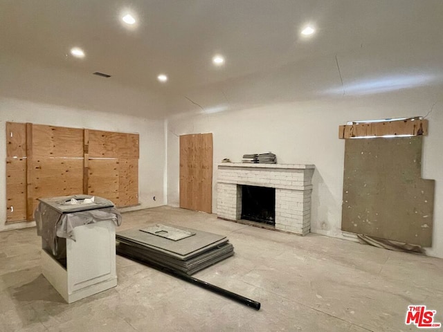 living room with a brick fireplace