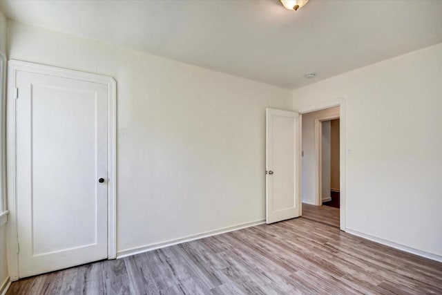 unfurnished bedroom with a closet and light wood-type flooring