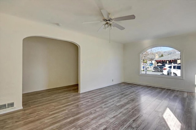 unfurnished room with hardwood / wood-style floors and ceiling fan