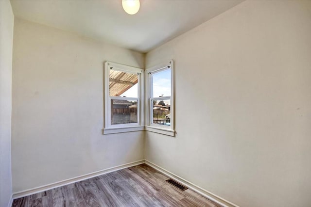 spare room featuring hardwood / wood-style flooring