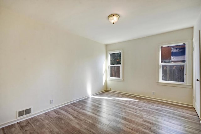 spare room with light hardwood / wood-style flooring