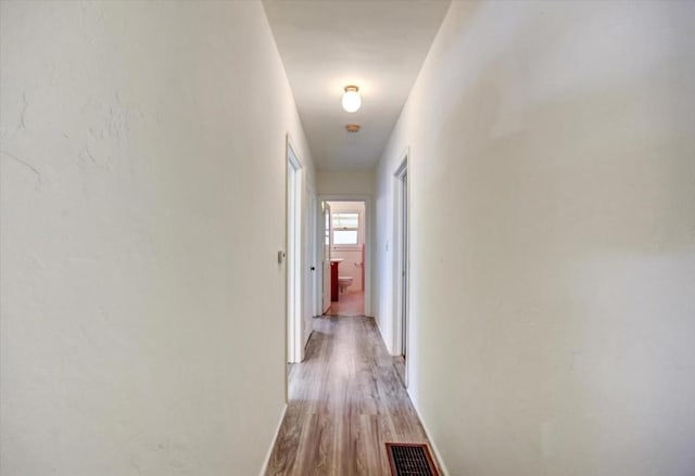 corridor featuring light hardwood / wood-style floors