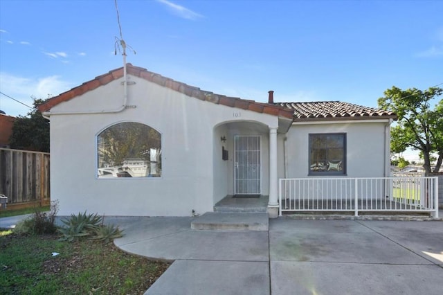 mediterranean / spanish house with covered porch