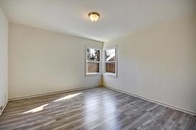 unfurnished room with dark wood-type flooring