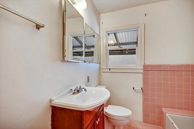 bathroom featuring toilet, vanity, and tile patterned flooring