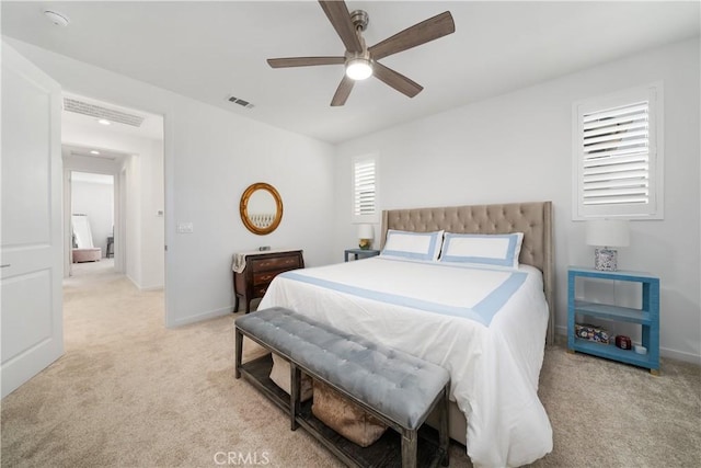 bedroom with ceiling fan and light carpet