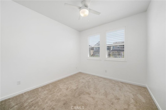 spare room featuring ceiling fan and light carpet