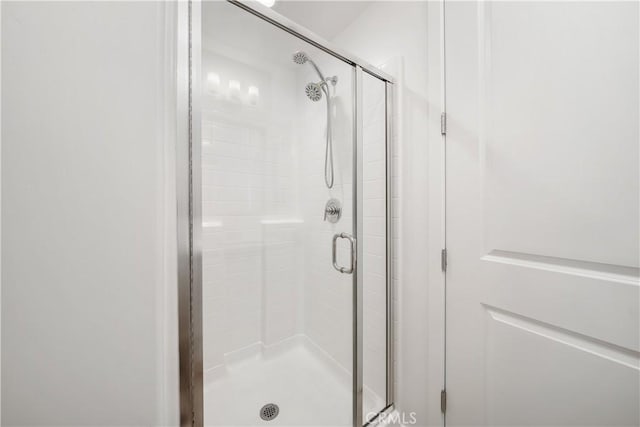 bathroom featuring a shower with shower door